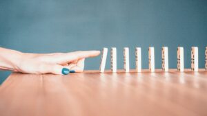 最初のドミノが次々と倒れていく様子。トリガーが行動を連鎖させることを表す写真